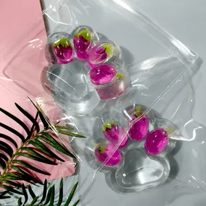 Detailed close-up of a transparent cat paw squishy toy with purple eggplant decoration inside