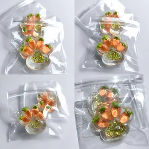 Detail view of transparent cat paw squeeze toy with glitter and carrot motifs in bags