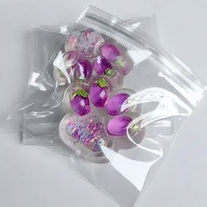 Close-up of transparent aurora cat paw squishy toy with purple strawberry glitters inside.