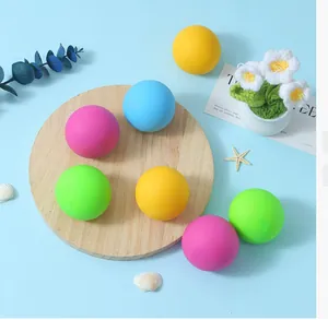 Set of colorful soft matte stress relief balls on a wooden board with decorative props