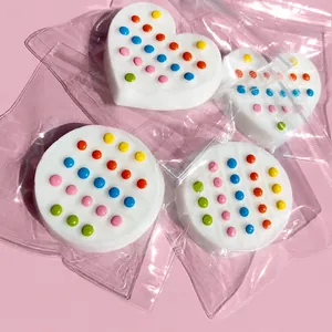 Detail of white silicone heart and round fidget toys with colorful pop-it dots
