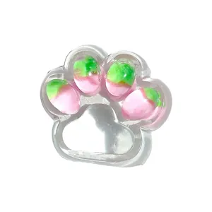 Transparent strawberry cat paw squishy toy for stress relief and office fidgeting.