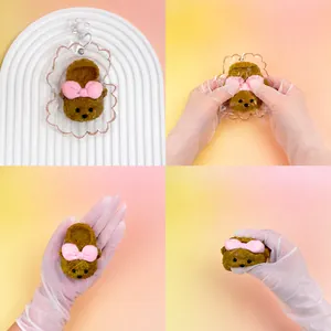 Detailed view of handmade silicone squishy toy slipper keychain being squeezed for stress relief.