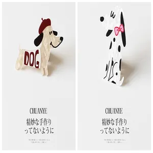 Close-up detail of cute cartoon dog hair clips featuring cream resin and spotted patterns