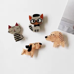 Detailed macro shot of cute animal acrylic hair clips in various cat and dog styles.