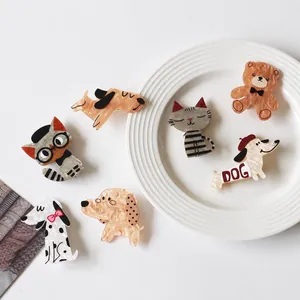 Detail view of cute acetate animal hair clips featuring various cat and dog designs