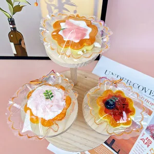 Close-up of three DIY silicone dessert-shaped egg tart squeeze toys with fruit toppings
