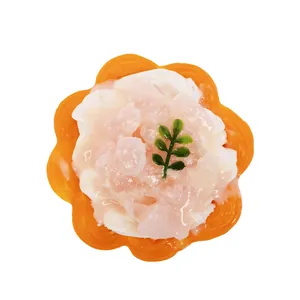 Close-up of a realistic silicone egg tart squishy toy with creamy white topping.