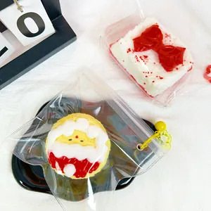 Detail view of Christmas themed silicone squishy toys in clear bags with yellow bells