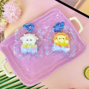 Close-up of handmade cute lion and sheep silicone squishy toys in blue packaging