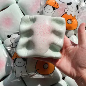 Close-up view of a mermaid-colored toast squishy toy showing its soft texture