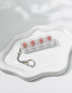 Detail view of a 4-key mechanical switch tester fidget keychain with transparent pink keycaps