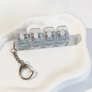 Detailed view of a 4-key transparent mechanical switch tester stress relief keychain.