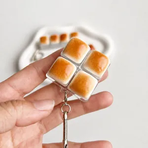 Close-up detail of a caramel bread fidget toy keychain with 4 mechanical clicky switches