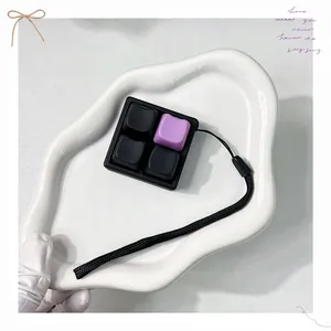 Close-up detail of a 4-grid mechanical switch tester fidget toy with black and purple keycaps