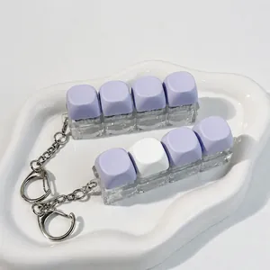 4-key mechanical switch tester keychain with pastel purple and white keycaps for stress relief
