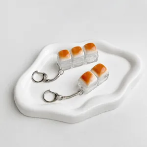 Close-up of caramel bread mechanical key fidget toys on a white decorative tray
