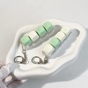 4-key mechanical keyboard cap fidget toy keychain in mint green and cream white finish