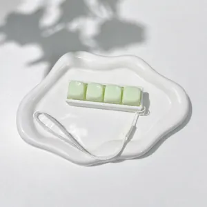 Detail view of the pale green 4-key keyboard fidget toy with a white hanging strap