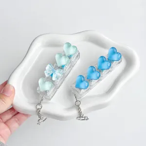 Detail view of heart-shaped transparent keycaps on a mechanical switch tester keychain