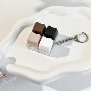 Close-up of cat-themed chocolate keycap fidget toy with 4-button sensory keys.