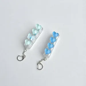 Translucent heart-shaped keycap fidget keychain with bow and heart charms decoration