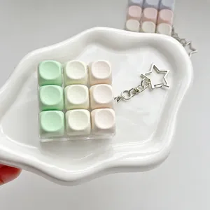 Close-up of 9-key macaron fidget switch tester keychain on white tray