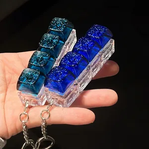 Close-up of galaxy themed mechanical keycap fidget toy with sparkling blue glitter and LED lighting