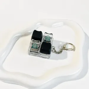 Macro view of tactile switches and cat-shaped keycaps on a fidget toy keychain