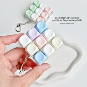 Detailed close-up of 9-key macaron mechanical switch fidget toy keychain in pastel colors