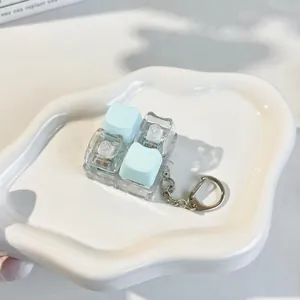 Detailed macro view of mechanical fidget keyboard keychain with cute cat-shaped keycaps