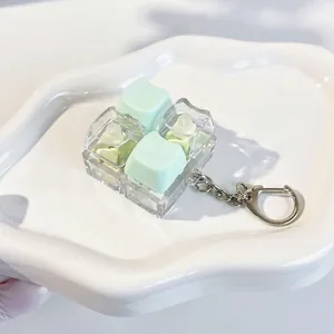 Adorable cat mechanical keyboard keycap fidget toy keychain in mint green and clear