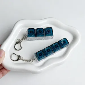 Detail shot of galaxy starry keycap fidget toy keychain with glitter