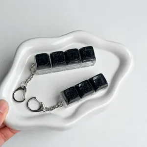 Handheld starry sky mechanical keyboard keycap fidget keychain set on a white plate