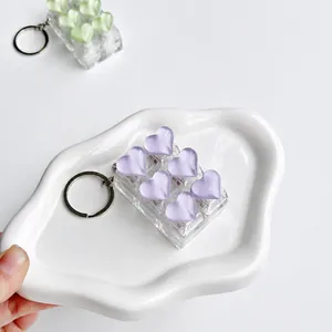 Detail shot of a 6-key decompression keychain with purple crystal heart buttons.