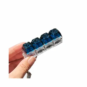 4-key mechanical keyboard fidget toy with glowing starry sky keycaps on a keychain