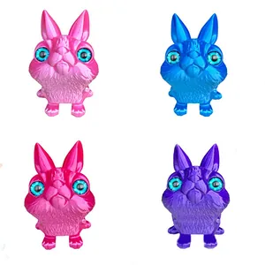 Display of four colorful 3D printed articulated rabbit models for cute desk decoration