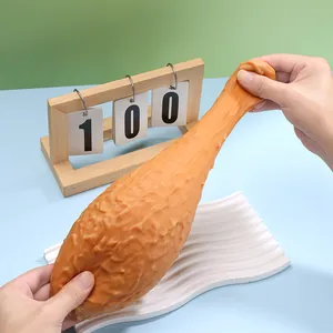 Macro view of a large realistic fried chicken leg stress relief toy being stretched by hand