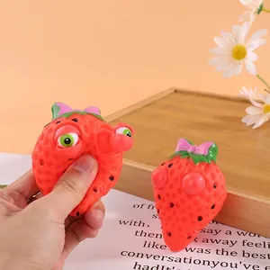 Strawberry pop eye squeeze toy for stress relief, fun fruit sensory fidget toy
