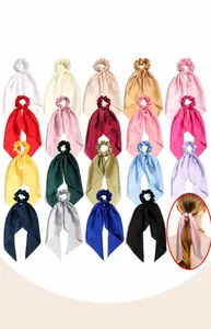 Elegant satin scrunchies with long streamers in various colors for hair styling.