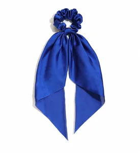 Detail view of blue satin ribbon scrunchie showing 8cm width and 26cm length dimensions.
