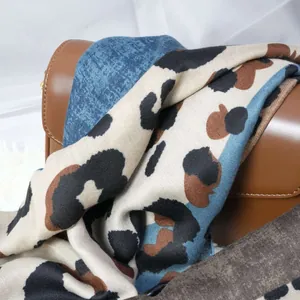 Primer plano de una bufanda con estampado de leopardo sobre un bolso de cuero