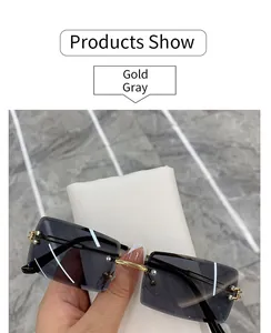 Detail view of rimless gray gradient sunglasses with elegant gold metal frame.