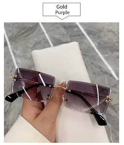 Macro view of rimless square sunglasses with purple gradient lenses and gold trim.