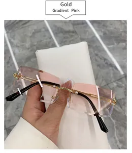 Rimless rectangular sunglasses with gold temples and gradient pink lenses