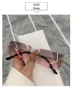Detail view of rimless square sunglasses with gold temples and pink gradient lenses
