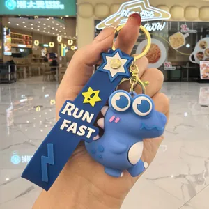 Vue détaillée d'un porte-clés dinosaure bleu en PVC avec sangle 'RUN FAST' souple