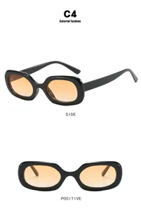 Detailed view of oval vintage sunglasses with black frames and orange lenses