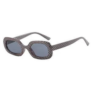 Vintage oval sunglasses with a stylish checkerboard frame and dark lenses for retro look.