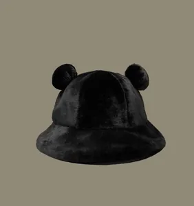 Macro detail view of a black fuzzy bucket hat featuring cute bear ears for winter warmth